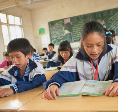 group of Chinese students reading their textbooks in China